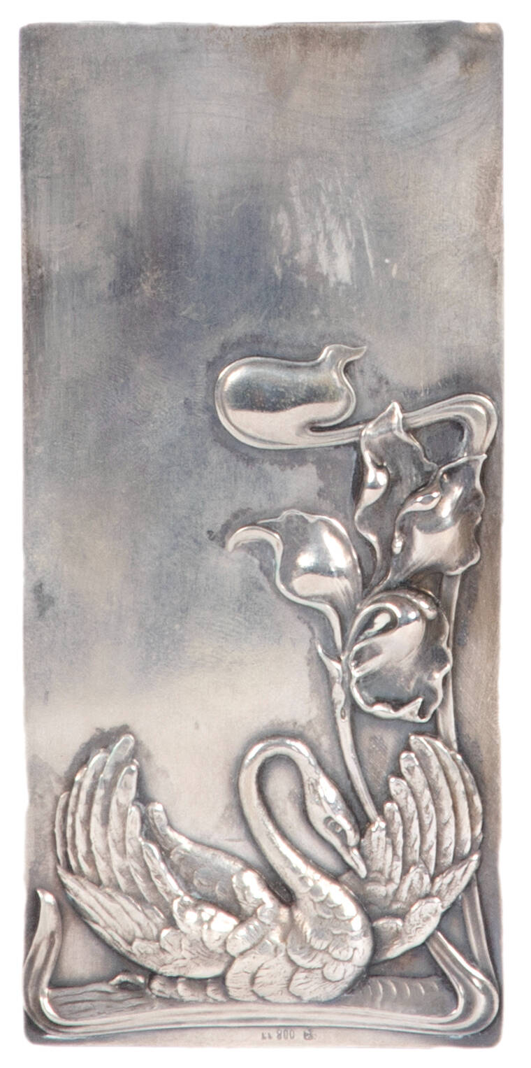 Silver plate with a flower and swan pattern.